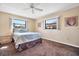 Cozy bedroom with neutral carpet and walls, two large windows providing ample natural light at 514 Pine Hollow Cir # 514, Englewood, FL 34223