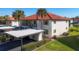 Two story building with covered parking and beautifully manicured landscaping at 514 Pine Hollow Cir # 514, Englewood, FL 34223