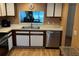 Bright kitchen featuring stainless steel appliances, wood cabinets, and a pass-through window to living area at 514 Pine Hollow Cir # 514, Englewood, FL 34223
