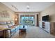 Bright living room with comfy seating, large window and view of patio at 514 Pine Hollow Cir # 514, Englewood, FL 34223