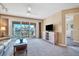 Bright living area with balcony access overlooking serene views, ceiling fan, and neutral color scheme at 514 Pine Hollow Cir # 514, Englewood, FL 34223