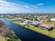 Beautiful aerial view of house overlooking lake in residential neighborhood at 849 Rotonda Cir, Rotonda West, FL 33947
