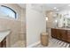 Elegant bathroom featuring dual shower, a large mirror, and wood cabinets at 849 Rotonda Cir, Rotonda West, FL 33947