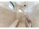 Bathroom shower area featuring tiled walls, built in bench, and niche for toiletries at 849 Rotonda Cir, Rotonda West, FL 33947