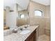 Bathroom showcasing granite counters, dual shower, and neutral-toned tile at 849 Rotonda Cir, Rotonda West, FL 33947