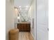 Bathroom showcasing a long mirror and granite counters with wooden cabinets at 849 Rotonda Cir, Rotonda West, FL 33947