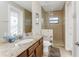 Bathroom features a granite countertop, spacious shower with glass door, and well-lit space at 849 Rotonda Cir, Rotonda West, FL 33947