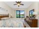 Bedroom with water view, boasts wood floors, ceiling fan, and sliding glass doors to a patio at 849 Rotonda Cir, Rotonda West, FL 33947