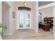 Welcoming foyer features elegant double doors, tile flooring, and a view of a well-lit home office at 849 Rotonda Cir, Rotonda West, FL 33947