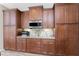 Kitchen featuring granite countertops, custom cabinets, a microwave, a toaster oven, a tile backsplash, and tile flooring at 849 Rotonda Cir, Rotonda West, FL 33947