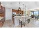 Kitchen featuring stainless appliances, granite countertops, and a breakfast bar with seating, open to the adjacent dining area at 849 Rotonda Cir, Rotonda West, FL 33947