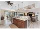 Open-concept kitchen featuring granite countertops, stainless steel appliances, and a breakfast bar overlooking the living area at 849 Rotonda Cir, Rotonda West, FL 33947