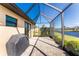 Outdoor lanai with black grille, beautiful view, and sliding glass doors at 849 Rotonda Cir, Rotonda West, FL 33947