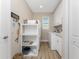 Functional laundry room with storage shelves, cabinets, and a washer/dryer, offering convenience and organization at 849 Rotonda Cir, Rotonda West, FL 33947