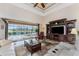 Bright living room with sliding glass doors to the screened patio and pool, vaulted ceilings, and comfortable furnishings at 849 Rotonda Cir, Rotonda West, FL 33947