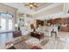 Bright and airy living room with high ceilings, recessed lighting, tile flooring, and an open view of the adjacent kitchen at 849 Rotonda Cir, Rotonda West, FL 33947