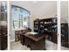 Spacious office featuring built-in bookshelves, a large window, and a dark wood desk at 849 Rotonda Cir, Rotonda West, FL 33947