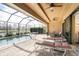 Covered patio with view of the pool and lake, perfect for relaxing and escaping the heat at 849 Rotonda Cir, Rotonda West, FL 33947