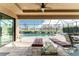 Covered patio view of the pool and lake, has ample room for dining and lounging in comfort at 849 Rotonda Cir, Rotonda West, FL 33947