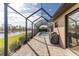 A beautiful screened-in pool and lanai with brick floors and a water view at 849 Rotonda Cir, Rotonda West, FL 33947
