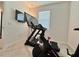 Bright home gym with Peloton bike and treadmill at 19060 Moscato Ct, Venice, FL 34293