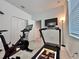 Home gym with Peloton bike and NordicTrack treadmill at 19060 Moscato Ct, Venice, FL 34293