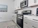 Modern kitchen with white cabinets and stainless steel appliances at 19060 Moscato Ct, Venice, FL 34293