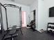 Home gym featuring power rack, weight bench, and dumbbell rack at 19060 Moscato Ct, Venice, FL 34293
