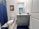 Modern bathroom with gray vanity and blue shower curtain at 19060 Moscato Ct, Venice, FL 34293
