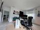 Bright home office features a standing desk, ergonomic chair, and ample storage at 19060 Moscato Ct, Venice, FL 34293
