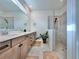 Spa-like bathroom with double vanity, large shower, and tile flooring at 19060 Moscato Ct, Venice, FL 34293