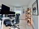 Modern home office features standing desk, ergonomic chair, and ample storage at 19060 Moscato Ct, Venice, FL 34293