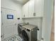 Bright laundry room, featuring washer, dryer, and ample storage at 19060 Moscato Ct, Venice, FL 34293