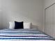 Spacious bedroom with striped bedding and closet at 19060 Moscato Ct, Venice, FL 34293
