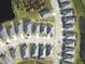 Aerial view of a community with numerous houses and a lake at 19060 Moscato Ct, Venice, FL 34293