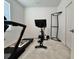 Home gym with Peloton bike and NordicTrack treadmill at 19060 Moscato Ct, Venice, FL 34293
