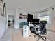 Bright home office features a standing desk, ergonomic chair, and ample storage at 19060 Moscato Ct, Venice, FL 34293