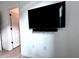Room with mounted TV, soundbar, and door to hallway at 19060 Moscato Ct, Venice, FL 34293