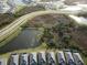 Aerial view of houses near a pond and road at 19060 Moscato Ct, Venice, FL 34293