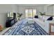 Spacious living room with a large sofa and blue rug at 19060 Moscato Ct, Venice, FL 34293