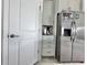 Kitchen with stainless steel refrigerator and white cabinets at 19060 Moscato Ct, Venice, FL 34293