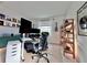 Spacious home office with standing desk, ergonomic chair, and built-in shelving at 19060 Moscato Ct, Venice, FL 34293