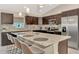 Island kitchen with granite countertops and dark wood cabinets at 2775 Wyola Ave, North Port, FL 34286