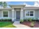 Gray house with dark gray door and landscaping at 2775 Wyola Ave, North Port, FL 34286