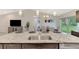 Modern kitchen with granite countertops, stainless steel sink, and breakfast bar at 2775 Wyola Ave, North Port, FL 34286