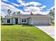 Gray house with a 2 car garage and well manicured lawn at 2775 Wyola Ave, North Port, FL 34286