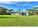 Large backyard with grassy area and home at 2775 Wyola Ave, North Port, FL 34286