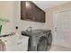 Laundry room with washer, dryer, and utility sink at 2775 Wyola Ave, North Port, FL 34286