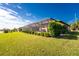 Landscaped backyard with screened enclosure and canal views at 849 Rotonda Cir, Rotonda West, FL 33947