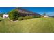 Spacious backyard with screened pool enclosure and water views at 849 Rotonda Cir, Rotonda West, FL 33947
